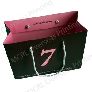 an empty paper bag with a color of pink inside and black from outside and a number 7 at the middle