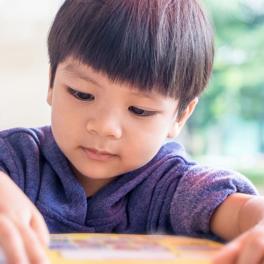 A boy is reading a book.