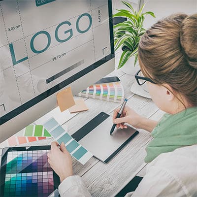 a woman is designing a logo